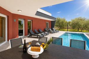 a villa with a swimming pool and a table and chairs at Villa LM in Krnica