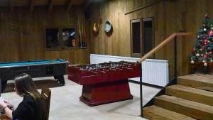 a woman in a living room with a christmas tree at Camping Can Fosses in Planoles