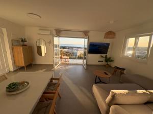 a living room with a couch and a table at Maris Loft Šimuni in Šimuni