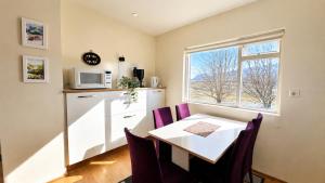 a small kitchen with a table and a window at Thorbrandsstadir Farm Holidays in Þorbrandsstaðir