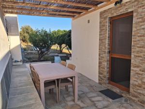 a table and chairs on a patio with a window at Villa Elia in Kástron