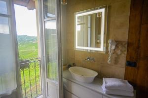 a bathroom with a sink and a mirror and a window at Agriturismo Cascina Sciulun in Monforte dʼAlba +87 photos