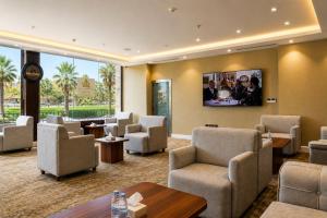 a waiting room with chairs and a tv on the wall at فندق دارك بارك حي الشاطئ Darak Park Hotel Jeddah in Jeddah