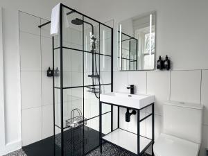 a white bathroom with a sink and a shower at Birchwood Pitlochry in Pitlochry +130 photos