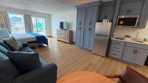 a living room with a couch and a refrigerator at Beachcomber Motel in Ocean City