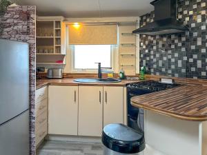 a kitchen with a sink and a stove top oven at Uk51412 - The Haven in Brechin