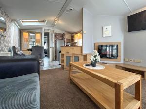 a living room with a couch and a table at Uk51412 - The Haven in Brechin