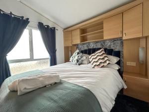 a bedroom with a large bed with blue curtains at Uk51412 - The Haven in Brechin +4 photos