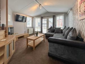 a living room with a couch and a tv at Uk51412 - The Haven in Brechin