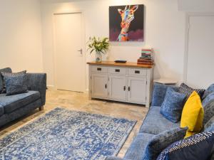 a living room with two couches and a table at The Alnwick Townhouse in Alnwick