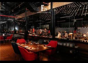 a restaurant with a table and red chairs and a bar at Golden Apartment in Da Nang Bay in Danang