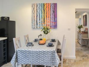 a dining room table with a blue and white table cloth at The Alnwick Townhouse in Alnwick