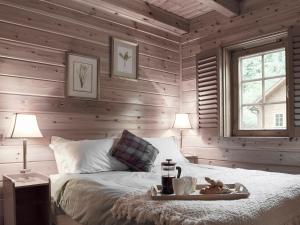 a bedroom with wooden walls and a bed with a tray on it at Alder - Uk5502 in Killin