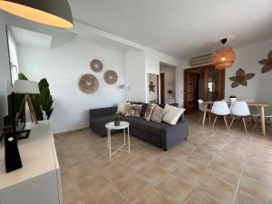 a living room with a couch and a table at Villa Chloe in Punta Grossa