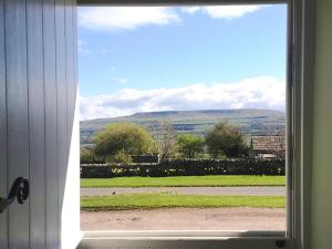 a window with a view of a field of grass at Lawson's Studio in Redmire