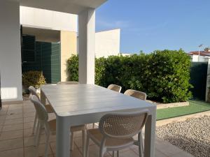 a white table and chairs on a patio at Villa Chloe in Punta Grossa +22 photos