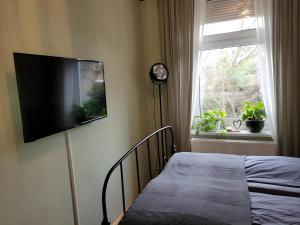 a bedroom with a bed and a flat screen tv on a wall at Neu! Fewo Fiedler I in Finsterwalde