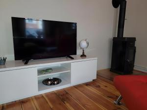 a flat screen tv sitting on top of a white entertainment center at Neu! Fewo Fiedler I in Finsterwalde