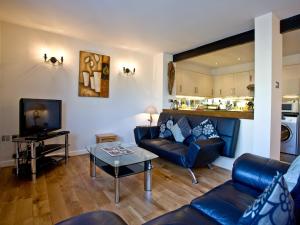 a living room with a couch and a table at 3 Torwood Gables in Torquay