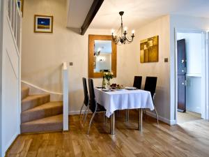 a dining room with a white table and black chairs at 3 Torwood Gables in Torquay