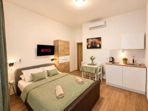 a large bedroom with a bed and a kitchen at Perello Old Town in Split