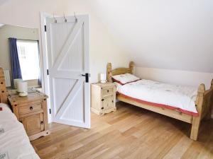a bedroom with a bed and an open door at Stable Barn - Hw7591 in Bettws-yn-Rhôs +9 photos