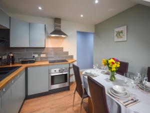 a kitchen and dining room with a table and chairs at Tay Views Apartment in Perth