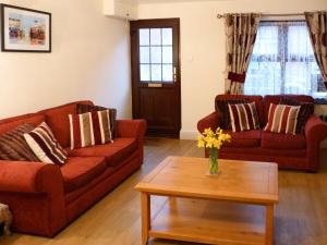 a living room with two couches and a coffee table at Watchkeeper's Cottage in Mundesley