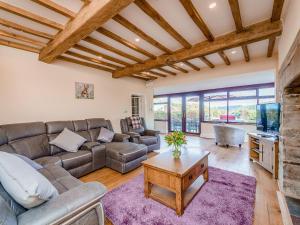 a living room with a couch and a table at Rhiew Banc in Aberhafesp