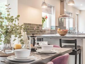 a kitchen with a table with dishes on it at Pennant in Llanerfyl