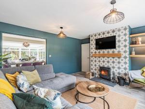 a living room with a couch and a fireplace at Pennant in Llanerfyl