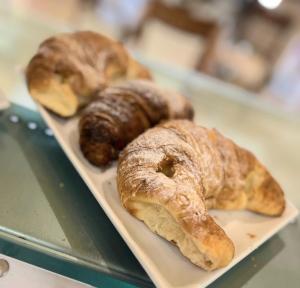 three pastries are sitting on a tray in a bakery at B&B Colori del Salento in Presicce