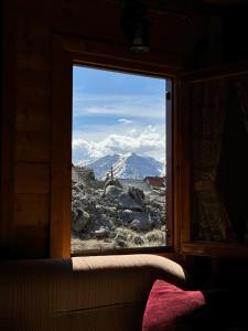 a view of a mountain through a window at Vikendica Varde Žabljak in Žabljak +13 photos