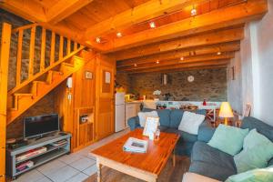 a living room with a couch and a table at La Grange de la Petite Ourse in Les Angles