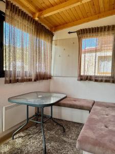 a small room with a table and a window at Vikendica Varde Žabljak in Žabljak