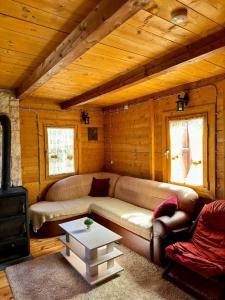 a living room with a couch and a table at Vikendica Varde Žabljak in Žabljak