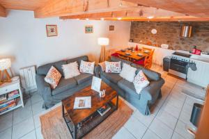 a living room with two couches and a table at La Grange de Cassiopée in Les Angles