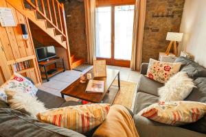 a living room with a couch and a table at La Grange de Cassiopée in Les Angles