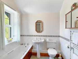 a bathroom with a sink and a toilet and a tub at Rockford Cottage Brendon in Countisbury +38 photos