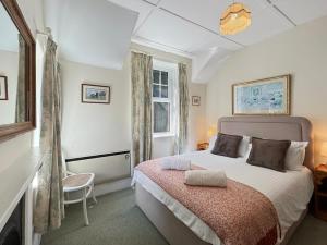 a bedroom with a large bed and a window at Rockford Cottage Brendon in Countisbury