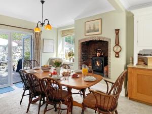 a dining room with a table and chairs and a fireplace at Rockford Cottage Brendon in Countisbury