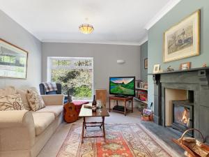 a living room with a couch and a fireplace at Rockford Cottage Brendon in Countisbury