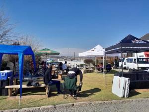 a couple of people sitting at tables under tents at Phomolo Guest House in Maseru