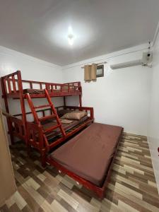a bedroom with a wooden bunk bed in a room at Ann's Place in Cabangan
