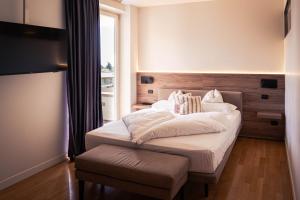 a bedroom with a large bed and a window at Tobago in Garda +119 photos