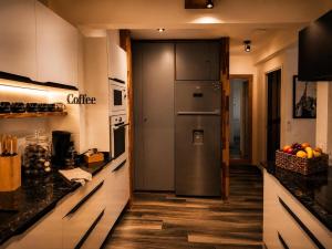 a kitchen with a stainless steel refrigerator at Ocean Eleven Boutique Stay - Sea View Sunset Terrace in Sainte-Anne