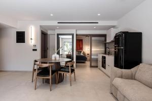 a kitchen and living room with a table and a couch at MonCasa suites in Agios Nikolaos +85 photos