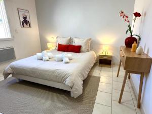 a bedroom with a bed with two pillows on it at Villa Elara provençale avec piscine 4 étoiles in Sarrians +41 photos