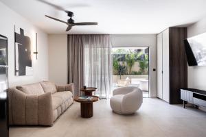 a living room with a couch and a chair at MonCasa suites in Agios Nikolaos