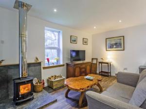 a living room with a fireplace and a couch at The Bungalow in Dingwall